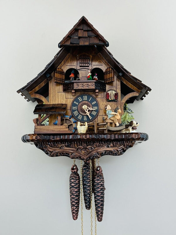 14" One Day Musical Cuckoo Clock Cottage with Boy on Rocking Horse, Moving Waterwheel, and Dancers